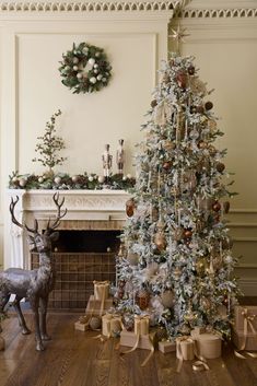 a decorated christmas tree in front of a fireplace