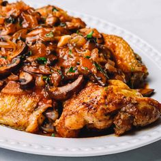 a white plate topped with chicken and mushrooms