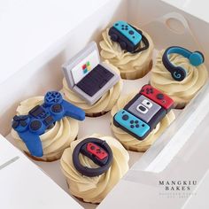 cupcakes decorated with video game controllers in a box