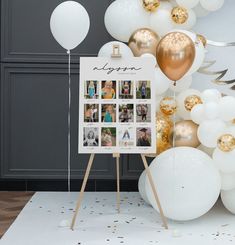 a white and gold balloon display with balloons in the background