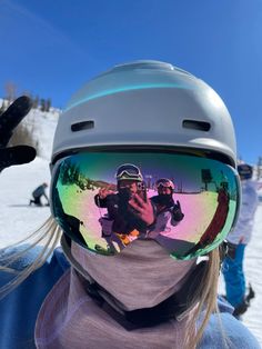 a person taking a selfie with their ski goggles on while they are snowboarding