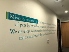 a sign that is on the side of a wall in an office building saying, mission statement of pets by providing people and animals that share knowledge