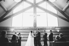 a bride and groom standing at the alter in front of their wedding party during a ceremony