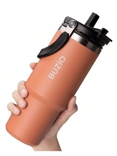 a hand holding an orange coffee cup with a black lid and the words buzo on it