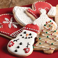 some decorated cookies are on a red plate