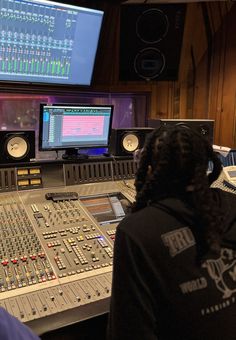 a man sitting in front of a mixing desk