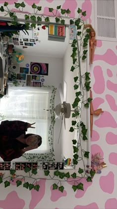 a mirror with ivy growing on it in a room that has pink and white walls