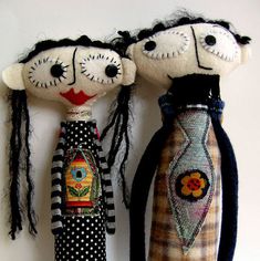 two dolls are standing next to each other