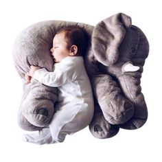 a baby sleeping on an elephant pillow with the words giant elephant baby pillow stuffed animal colorful toy