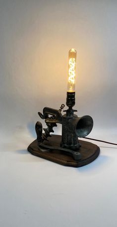 a light that is sitting on top of a piece of wood with a wire attached to it