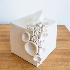 a white tissue box with buttons on it