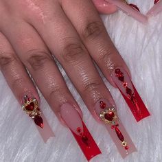 a woman with red and gold nail designs on her nails