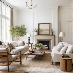 a living room filled with furniture and a fire place in front of a large window