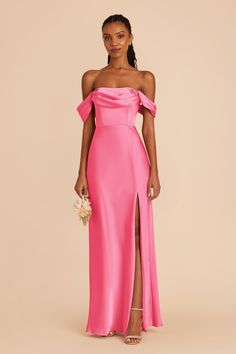 a woman wearing a pink dress with an off the shoulder slit