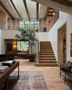 a living room filled with furniture and a staircase