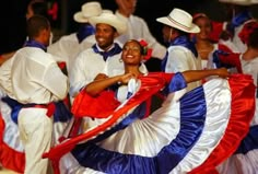 a group of people that are standing around each other with some flags on their backs