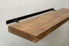 "When buying shelves worth $250 or more, a 6Lx4D inches size shelf as a gift Description. -Floating shelves made of oak, ash, walnut. -Shelves in rustic style  -Bookshelves in a rustic style -Kitchen shelves with bracket All of our shelves are 1.25 inches thick and consist of a single board without glue. Each shelf is individual in structure, color, so the final product may differ from the one shown in the photo. All voids and knots that are on the wood are filled with resin in the color of the selected wood. We use only transparent VOC-free resin. The product includes a metal bracket HEAVY DUTY, which can be easily installed by yourself. SIZE OPTIONS: Length: 6\" to 60\" Width: 4\" to 10\" Thickness: 1.25\" CUSTOMIZED ORDER: if you need a specific shelf size, please contact me via ETSY or Style Bookshelves, Leather Strap Shelves, Floating Kitchen Shelves, Live Edge Table Tops, Walnut Floating Shelves, Live Edge Shelves, Shelves Bathroom, Shelf Hardware, Walnut Shelves