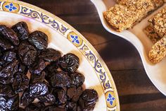 raisins and granola bars are on plates next to each other, along with one another