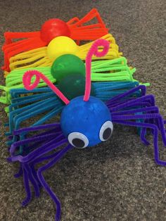 a colorful spider made out of plasticine on the ground