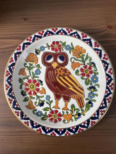 a decorative plate with an owl painted on it