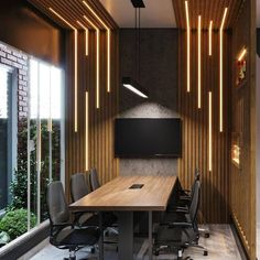 an empty conference room with wooden paneling and lights hanging from the ceiling above it