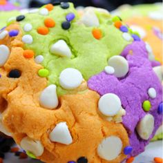 colorful cookies with white, green, and purple frosting on top of each other