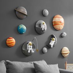 a living room filled with furniture and lots of space related wall art on the walls