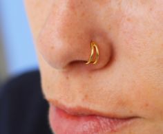 a close up of a person with a nose ring