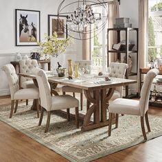 a dining room table with chairs and a chandelier