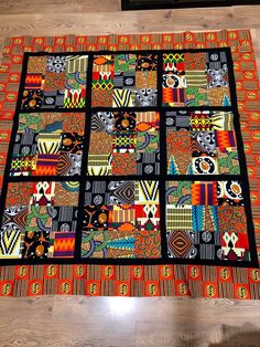 a multicolored patchwork quilt on a wooden floor