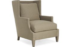 an upholstered chair with nail accents on the armrests and foot rest