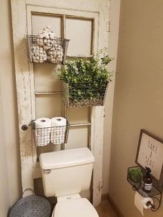 a white toilet sitting in a bathroom next to a wall mounted shelf with baskets on it