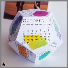 an origami calendar is displayed on a table