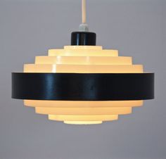 a black and white light hanging from a ceiling