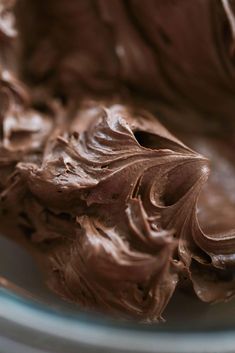 chocolate frosting in a glass bowl with a spoon