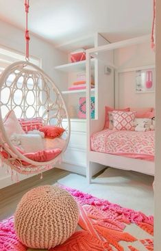 a pink and white bedroom with a hammock hanging from the ceiling