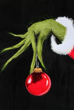 an acrylic painting of the grin face hanging from a christmas ornament