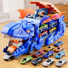 an assortment of toy cars and vehicles in a playroom with a dinosaur car carrier