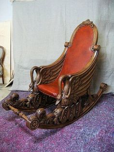 an old fashioned rocking chair sitting on top of a purple carpet