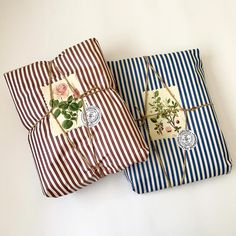 two wrapped presents sitting on top of each other