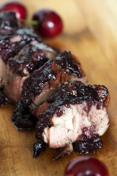 a piece of meat with cherries on the side