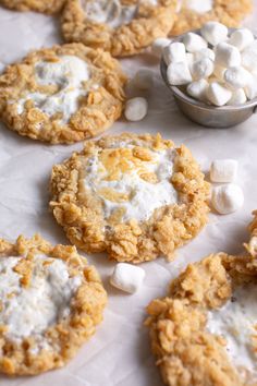 several cookies with marshmallows are on the table