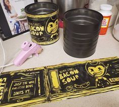 two black buckets sitting on top of a counter