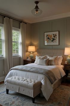 a bedroom with a large bed and two lamps on either side of the window sill