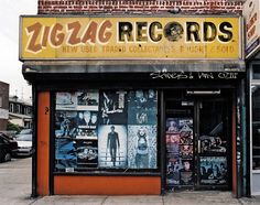 an old record store with graffiti on the front