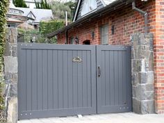 a brick house with an iron gate in front