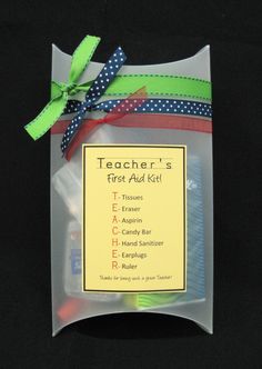 the teacher's first aid kit is packaged in a clear plastic bag with ribbon