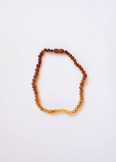 a beaded bracelet with yellow beads on a white background