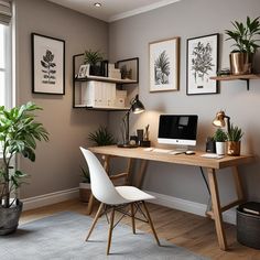 a home office with plants and pictures on the wall above the desk, along with a white chair