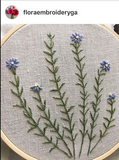 a close up of a cross stitch pattern with blue flowers on it and text that reads, florembroideryga